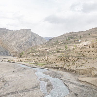 River through a stepped canyon under a cloudy sky. Photo by Sonam Choekyi Lama.