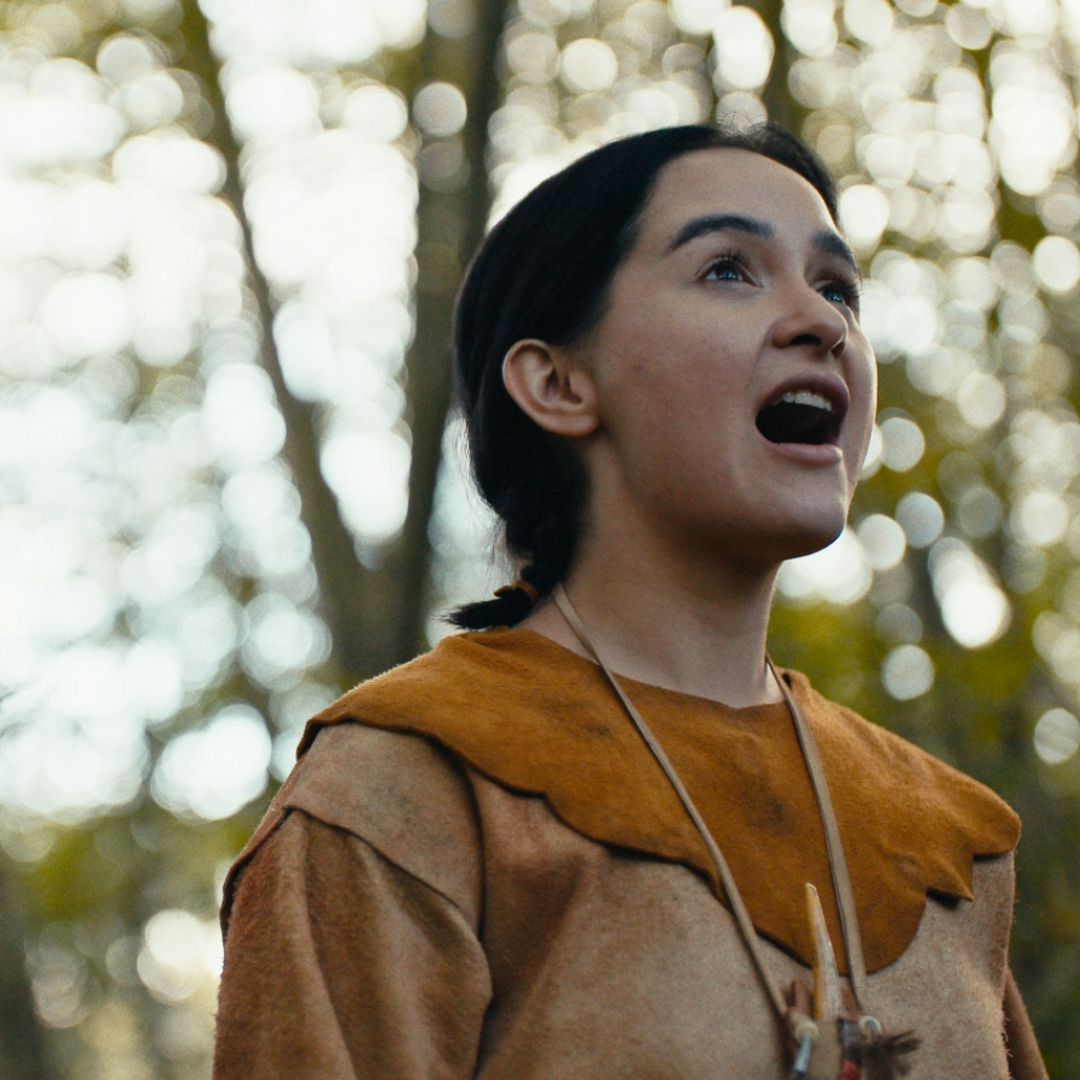 Still of actor Kaitlyn Yott from "Les Filles Du Roi" in a forested area