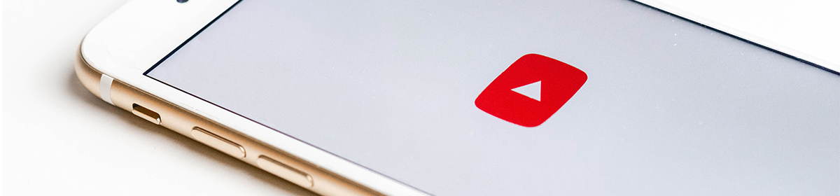 a smartphone with a Youtube icon onscreen; photo credit: sarah kurfess on unsplash